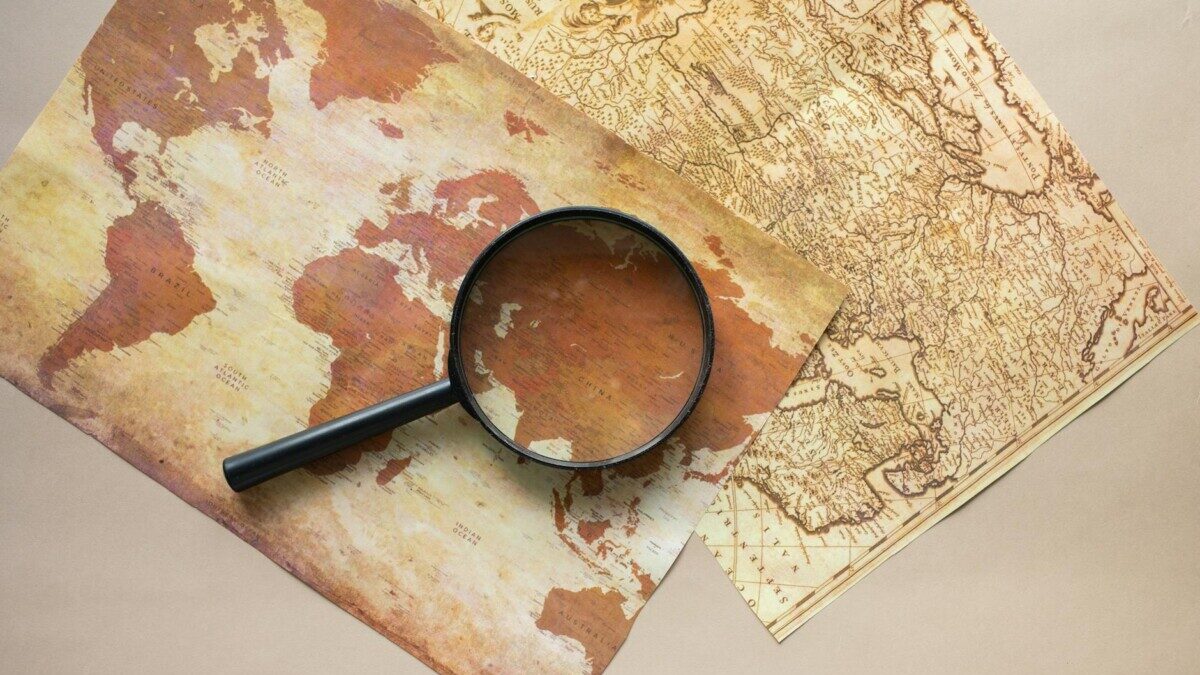 magnifying glass placed on maps
