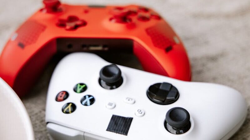 close up shot of white and red game controllers